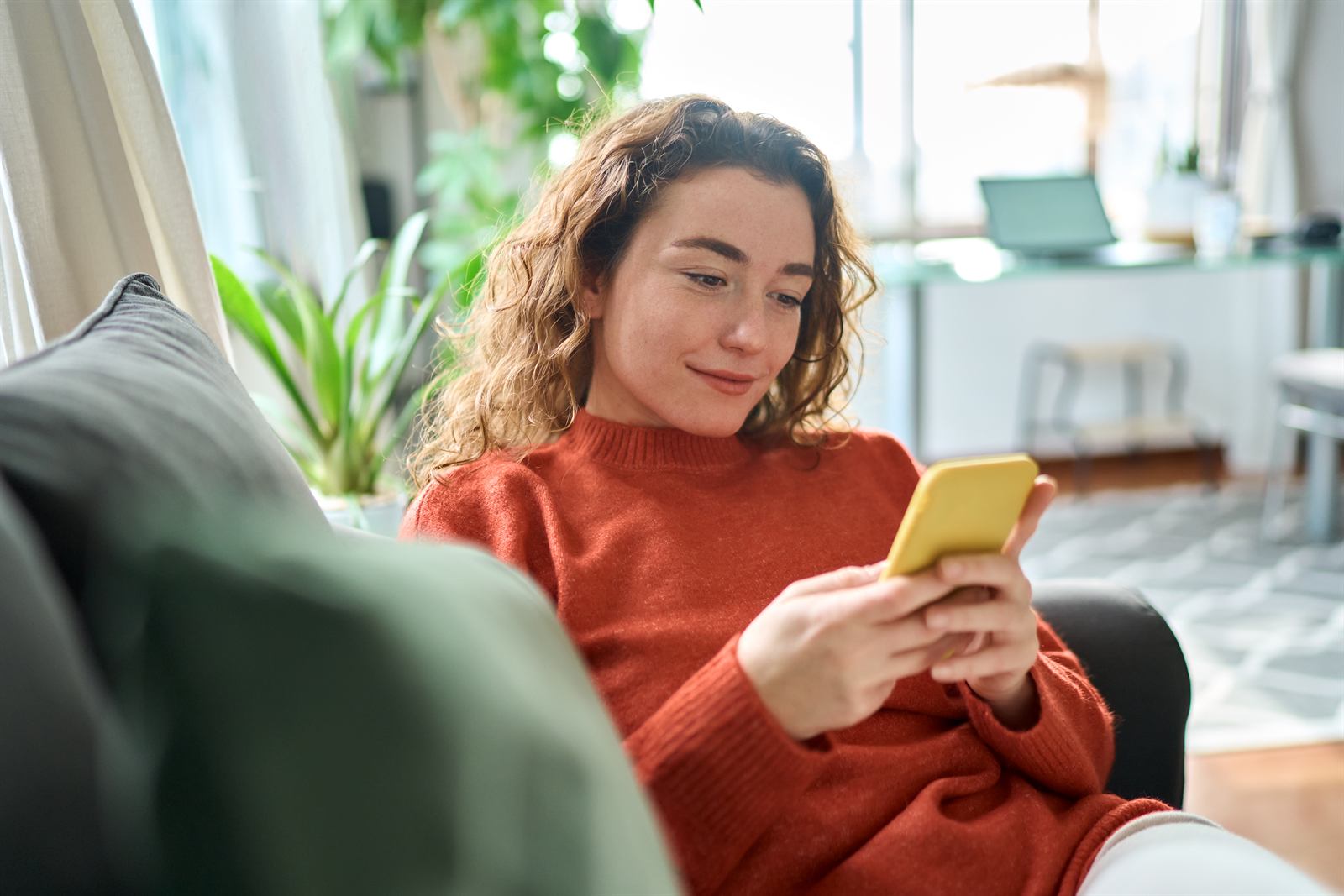 A telehealth patient joining a visit from home on her phone